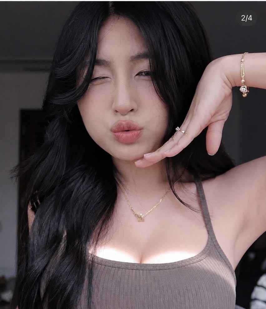 Woman with long dark hair looking toward the camera
