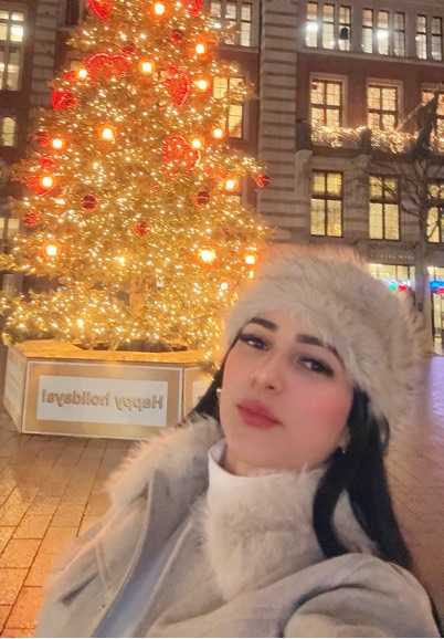 Portrait of a woman in a winter hat under warm evening lights